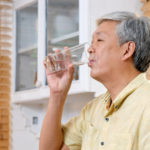 Senior man drinking a glass of water