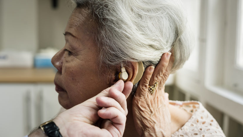 woman being fitted for hearing aids