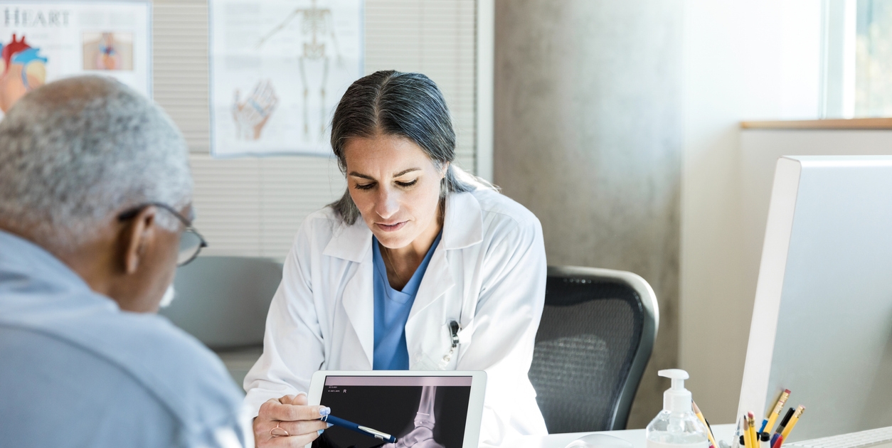 Orthopedist discusses senior patient's foot x-ray