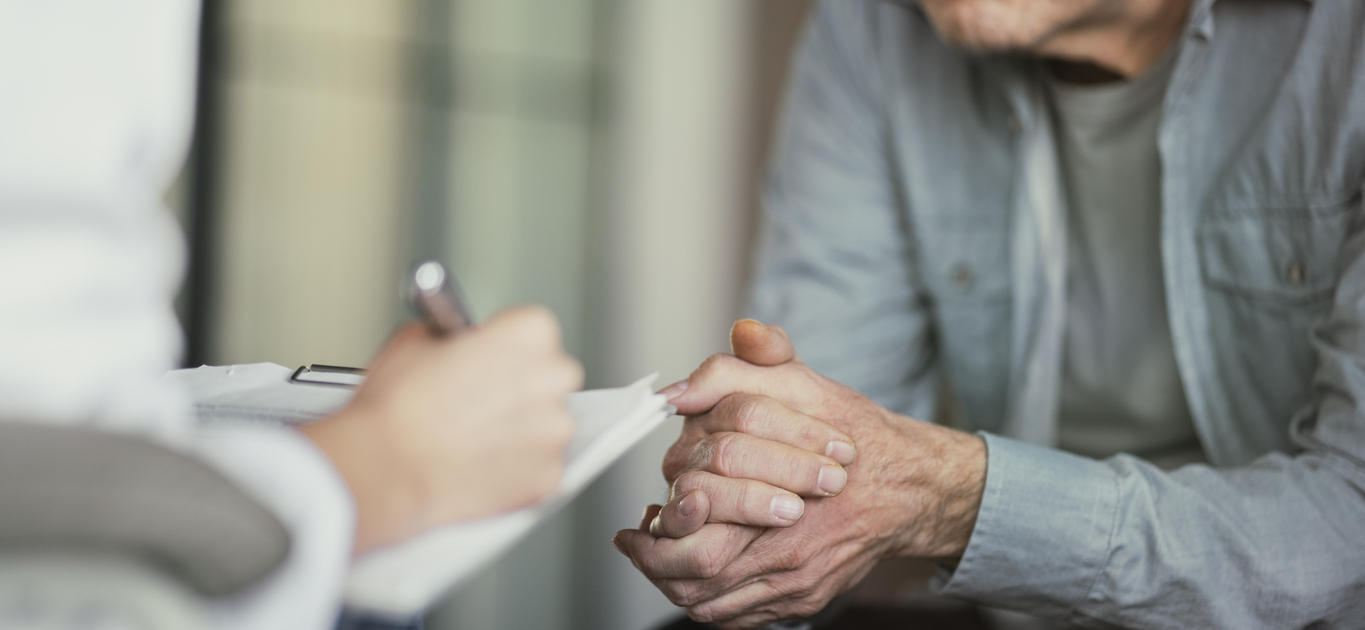 Doctor talks with patient and takes notes